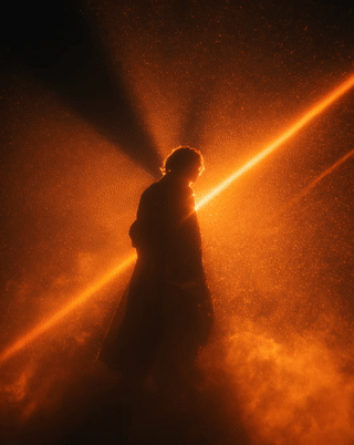 Undefined silhouette hit by a sharp cinematic spotlight